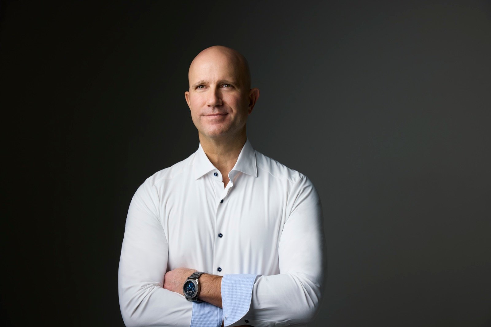 Marvin J. Schmidt in a navy suit, formal editorial portrait.